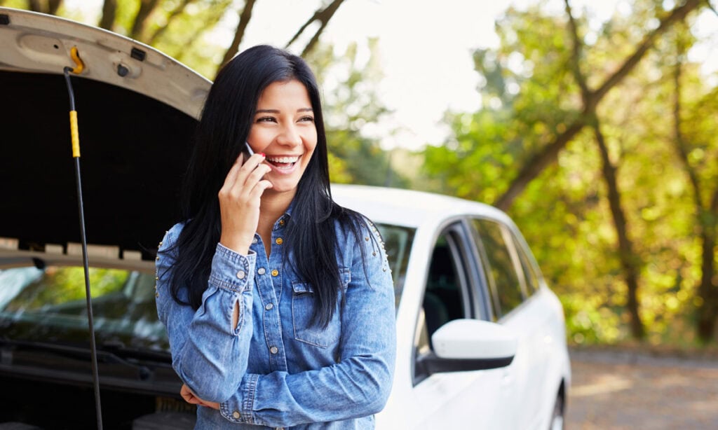 a woman calling for a tow truck since her car broke down