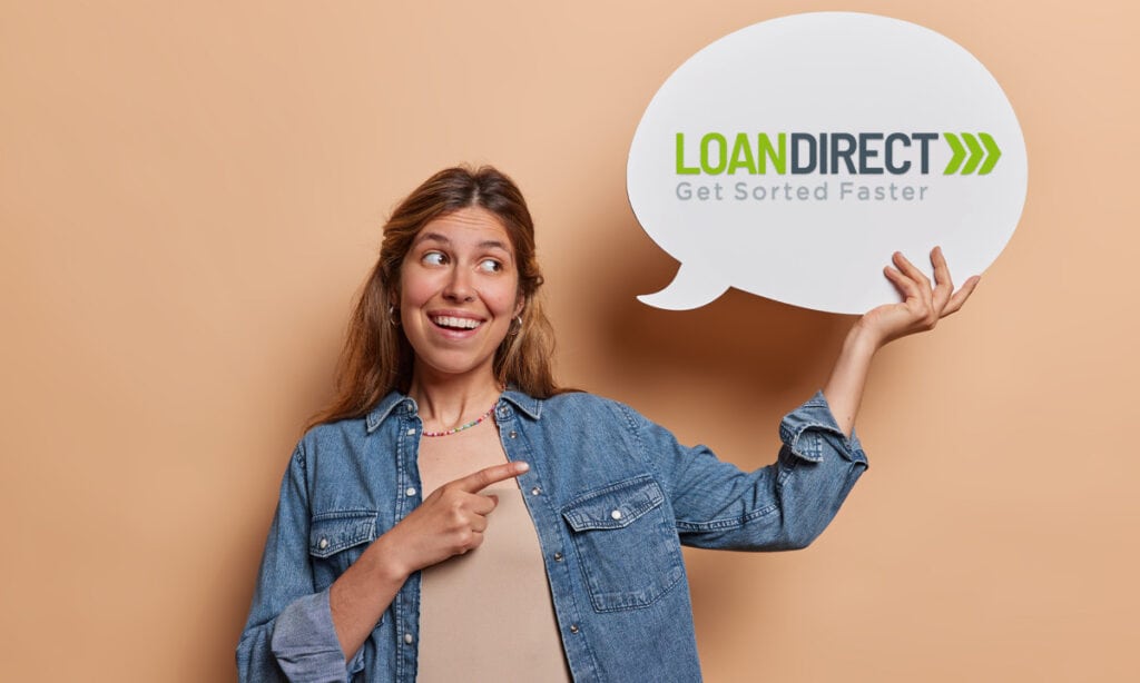 a woman holding up a Loan Direct sign